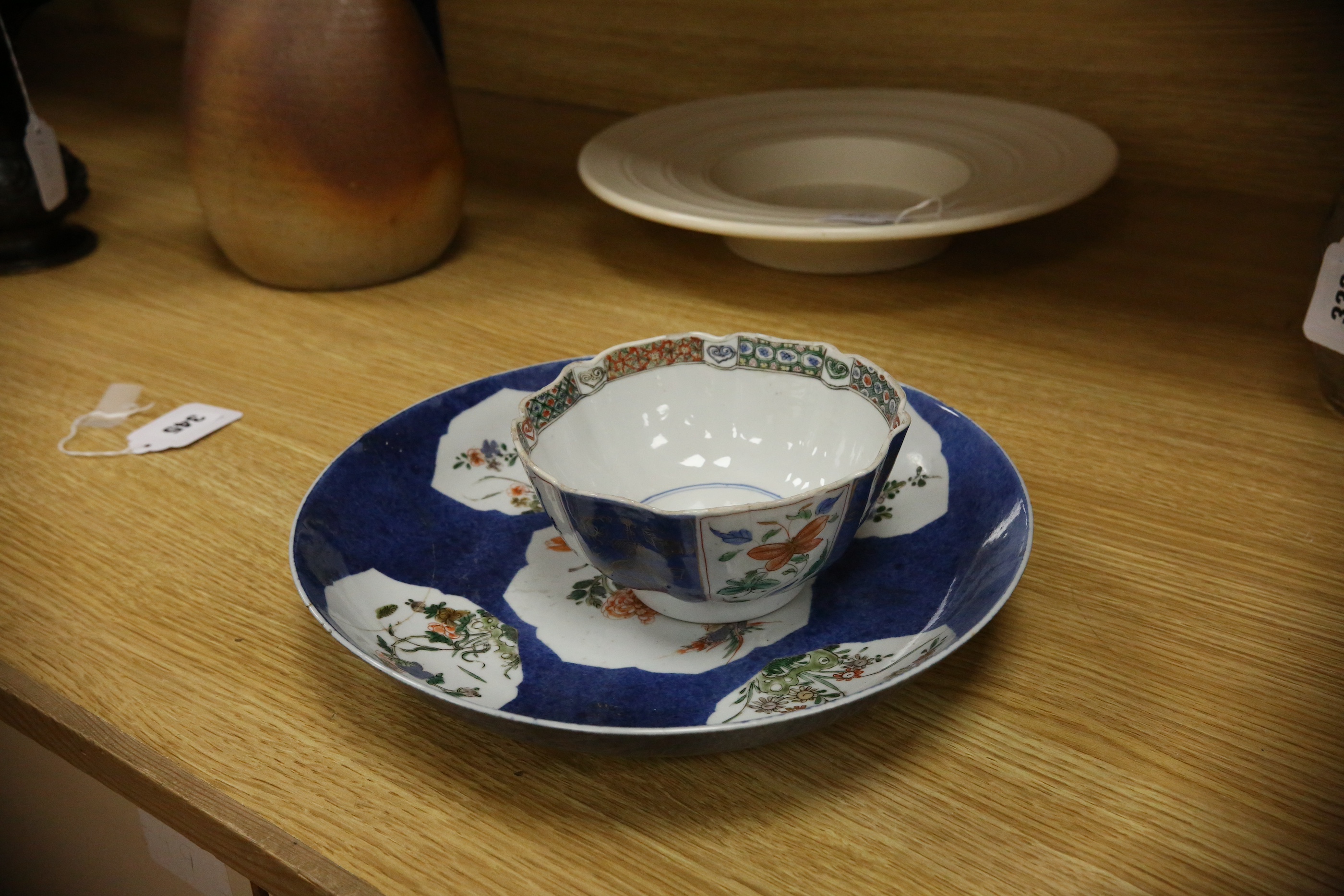 A Chinese famille verte powder blue ground bowl and a similar dish, both Kangxi period, 27.5cm diameter. Condition - dish poor, bowl fair